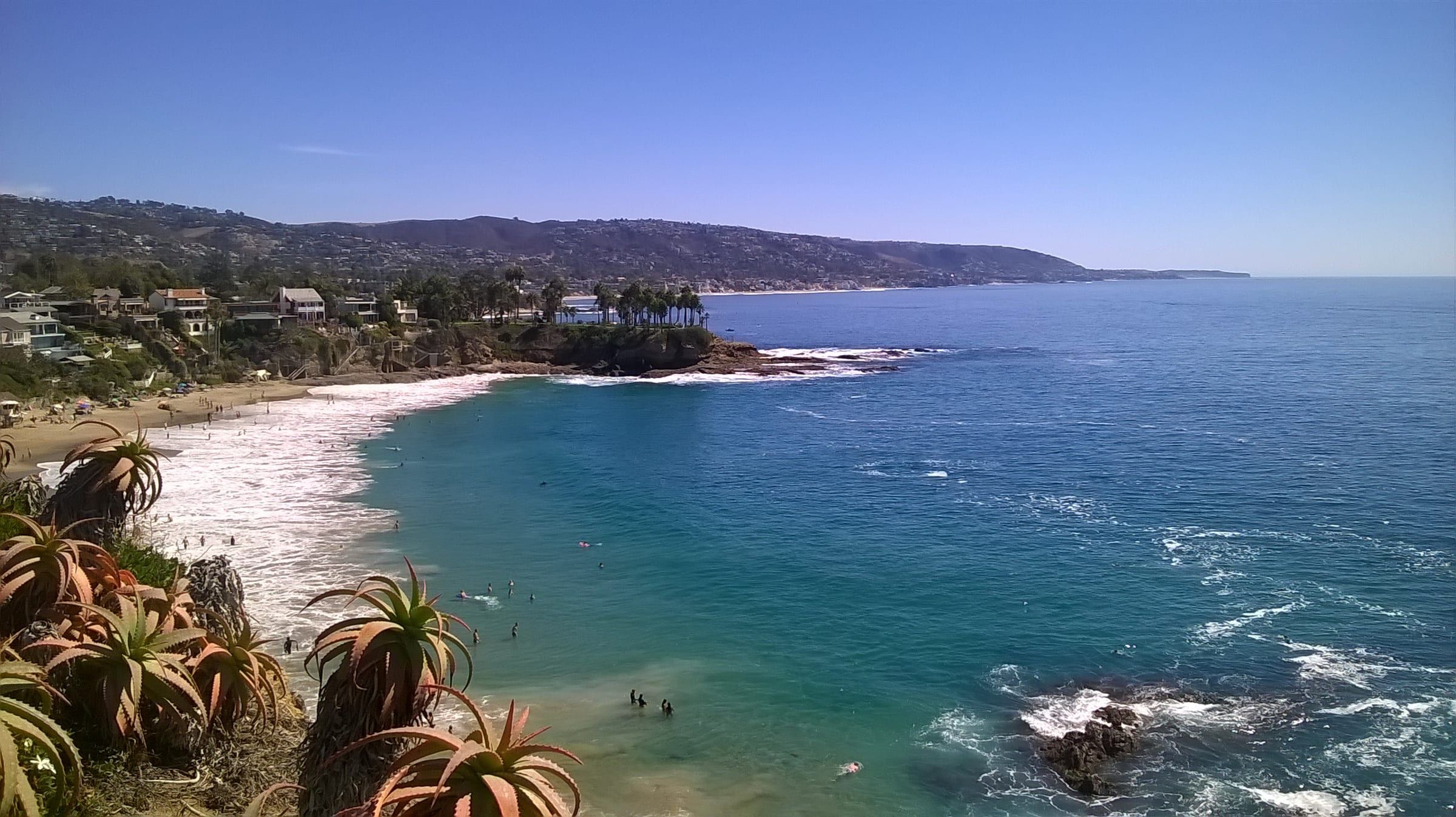 Crescent Bay in Laguna Beach: a curved beach and rocky point seen from the bluff