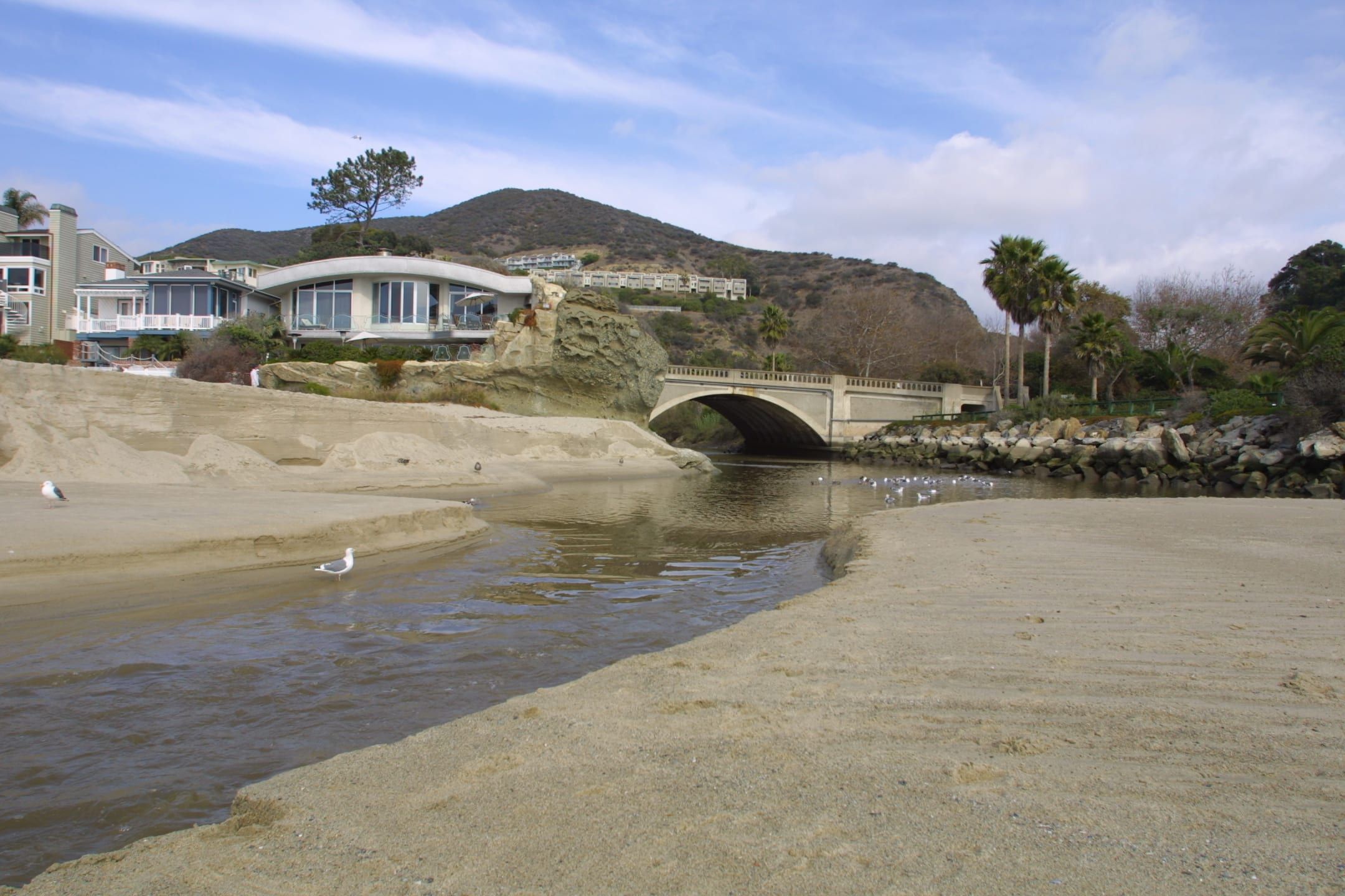 Aliso Creek crossing the sand to the ocean at Aliso Beach after breaching the sand berm