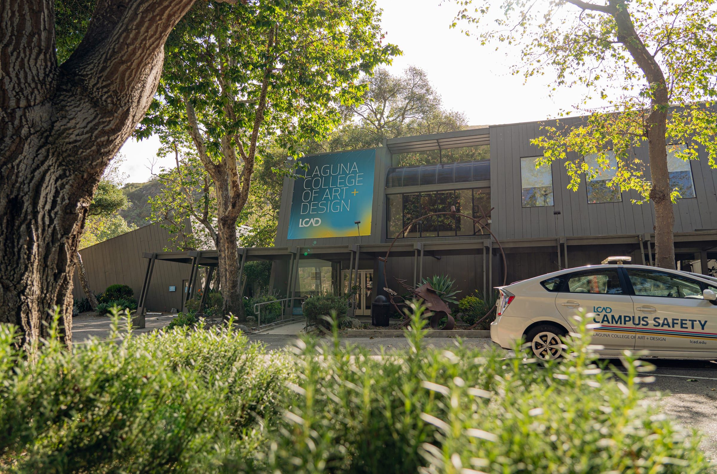 The main campus building of Laguna College of Art + Design on Laguna Canyon Road, with the college banner on its front