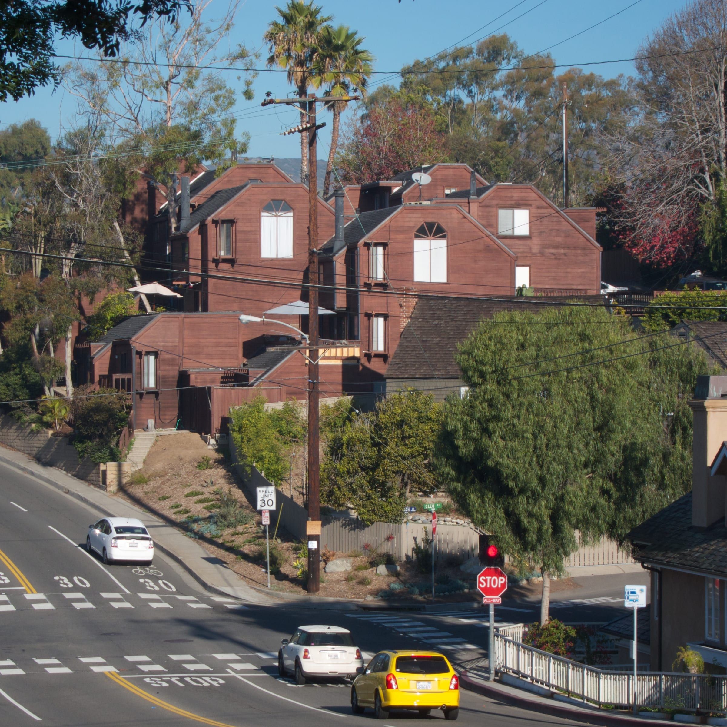 Houses and overhead utility lines beside a Laguna Beach street