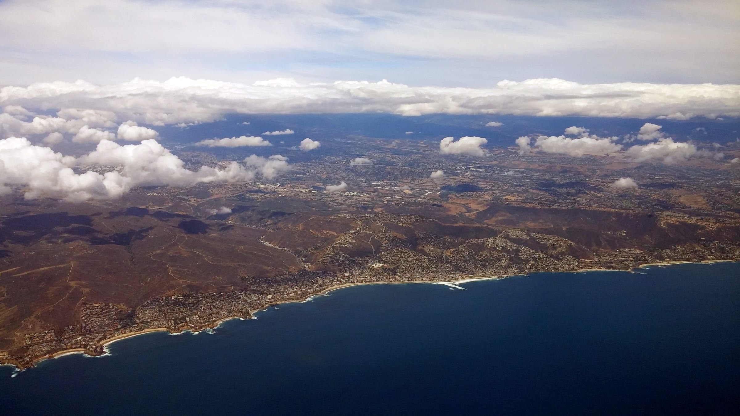 Aerial view of the Laguna Beach shoreline and the dry hills behind it