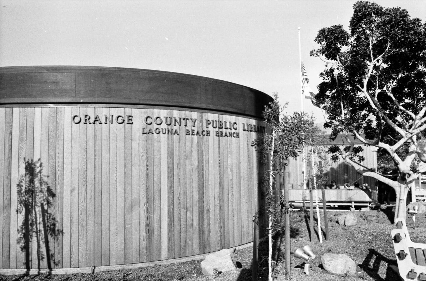 Historical photo, circa 1980s: the curved wood wall of the Laguna Beach Branch of the Orange County Public Library, with the branch name in raised letters