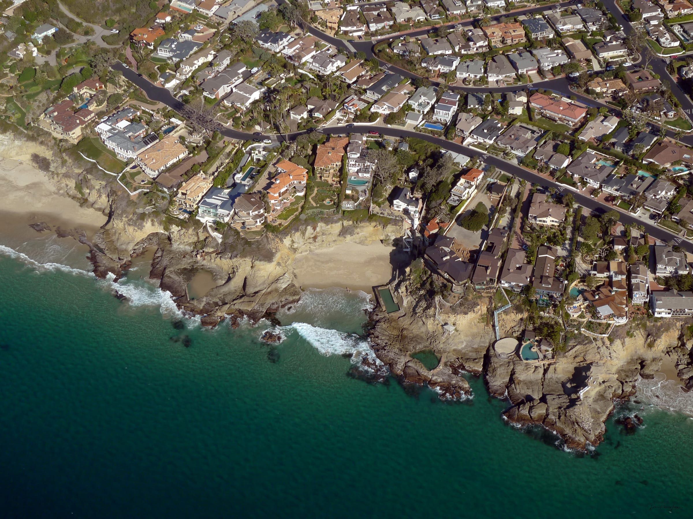 Aerial view of the arching rocks and homes at Three Arch Bay in Laguna Beach